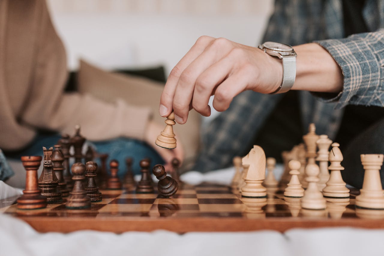 Chess match close up, highlighting strategic moves and intense concentration. Perfect for depicting intellectual games.